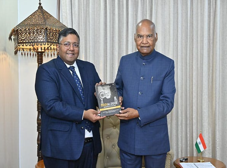 Ashwin Fernandes presents his new book "Modialogue" on PM Modi's Mann Ki Baat to former President Ram Nath Kovind.